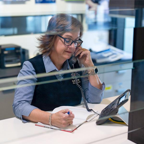 Woman behind a desk on the phone