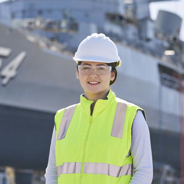 Woman standing in front of ship