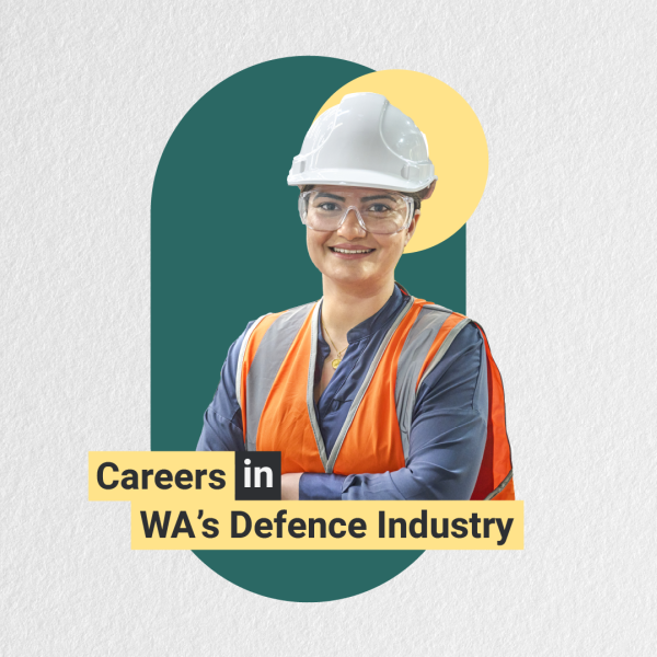  A woman wearing a hard hat and safety vest stands beside a sign that reads "Careers in the Defense Industry."